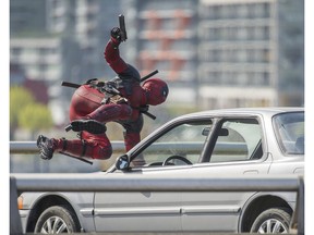 VANCOUVER. APRIL 7, 2015. Character from the movie Deadpool, starring Ryan Reynolds, is seen running and jumping over cars on the Georgia viaduct in Vancouver, B.C., April 7, 2015. (Arlen Redekop photo / PNG staff)