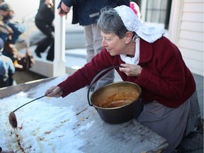 Nancy Hager pours hot syrup over cold snow to produce taffy for families to taste at the Maple Syrup Festival at the John R. Park Homestead Conservation Area, Sunday, March 3, 2013.