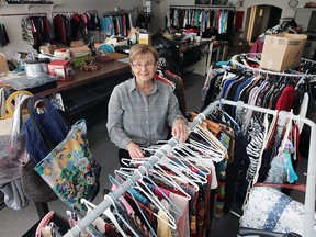 Nancy Allen, a volunteer with The May Court Club of Windsor, sorts through some of the donated items on Friday, February 19, 2016, at the Windsor, ON. shop. After being shut down for more than a year because of a fire the shop is scheduled to open in early March.