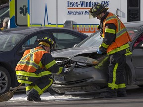 Windsor firefighters work at the scene of a minor motor vehicle collision on Howard Ave., north of Tecumseh Rd., Monday, Feb. 22, 2016.