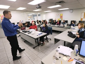 Augie Ravija teaches a class on the Canadian banking system to new arrivals to Canada at the New Canadians' Centre of Excellence in downtown Windsor on Monday, Feb. 29, 2016.