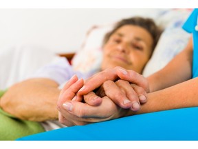 Nurse holding elderly patient's hands. Photo by fotolia.com.
