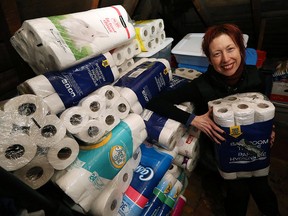 Tamara Kowalska is photographed with a load of toilet paper at the Windsor Youth Centre in Windsor on Tuesday, Feb. 9, 2016. A local teen donated several packs of toilet paper to the centre.