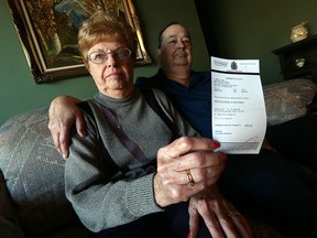 June and Ron St. Amour hold up a parking ticket they received Jan. 19 while visiting Windsor Regional Hospital at their home in Windsor on Monday, Feb. 1, 2016. The couple thinks the hospital needs to do something about the lack of parking.