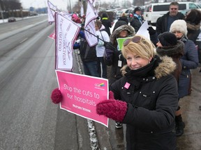 Registered nurse Diane Valeri takes part in an information rally along Tecumseh Road East in Windsor, Ont. on Feb. 15, 2016.  Several dozen registered nurses and leaders with the Ontario Nurses Association conducted  the rally to protest ongoing cuts in staffing levels at area hospitals.
