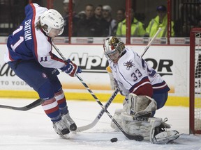 Windsor's Connor Chatham, left, misses on a scoring opportunity against Hamilton's Kaden Fulcher in OHL action between the Windsor Spitfires and the Hamilton Bulldogs at the WFCU Centre, Sunday, Feb. 21, 2016.
