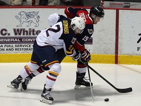 The Windsor Spitfires Christian Fischer battles for the puck with the Barrie Colts Greg DiTomaso at the WFCU Centre in Windsor on Thursday, February 25, 2016. The Spitfires defeated the Colts 4-2.