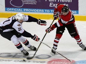 The Windsor Spitfires Logan Brown tries to block a shot from the Ottawa 67's Evan de Haan in this October 2015 file photo.