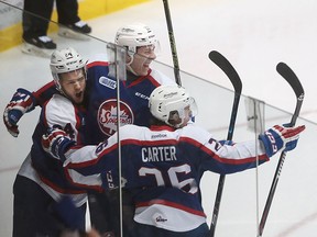 Windsor Spitfires Mads Eller (L), Logan Stanley and Cole Carter celebrate a goal during their game at the WFCU Centre in Windsor, Ont. in this January 2016 file photo.