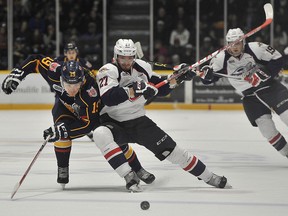 Rasmus Andersson of the Barrie Colts battles with Hayden McCool of the Windsor Spitfires during first period OHL action held Saturday at the Barrie Molson Centre in this 2016 file photo.