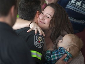 Catherine Marcoux holds her 11 month-old son, Roman Marcoux, as she hugs EMS paramedic Rick St. Pierre at the 5th annual Windsor-Essex EMS Survivor Day at the St. Clair Centre for the Arts, Friday, Feb. 26, 2016.  Roman Marcoux's life was saved by first responders after he had complications at birth.