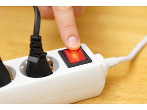 Turn off the button on power connector to save on electricity bill. Photo by fotolia.com.