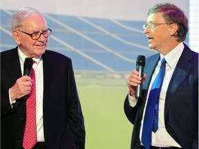 Waren Buffet (L) and Bill Gates (R) at the nationwide launching ceremony of electric vehicle BYD M6 in Beijing on September 29, 2010.  US billionaire investor Buffett said the previous day that Chinese battery and auto maker BYD was the "right choice for me", two years after his Berkshire Hathaway bought a stake in the firm. Gates and Buffett will host a banquet for China's super-rich which has sparked debate about Chinese philanthropy, amid reports that wealthy invitees have been reluctant to attend.