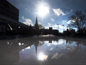 Windsor city hall and All Saints Church are reflected in the ice rink at Charles Clark Square in Windsor, Ont. on Feb. 3, 2016.