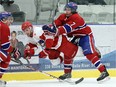 The Lakeshore Canadiens Joe Binder lays a hit on the Mooretown Flags Trevor Bogaert at the Atlas Tube Centre in Lakeshore on Friday, February 12, 2016.