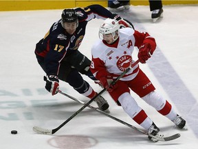 Spitfires Logan Stanley chases Greyhounds Zachary Senyshyn at the WFCU Centre in Windsor on Thursday, Feb. 18, 2016.