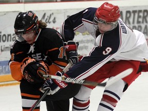 The Essex's Anthony Cristofaro, left, tangles with Alvinston's Mark McNally Tuesday at the Essex Centre Sports Complex during Game 1 of the Schmalz Cup quarter-final. The 73's beat the Flyers 9-0. TYLER BROWNBRIDGE