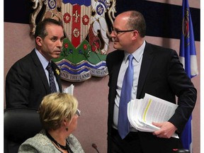 In this file photo, Windsor Mayor Drew Dilkens confers with Acting Mayor Bill Marra at a city council meeting which included presentation of the key of the city to University of Windsor Lancers CIS Champion women's basketball team Monday April 20, 2015. (NICK BRANCACCIO/The Windsor Star)