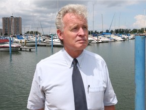 Tim Byrne, director of watershed management for ERCA inspects the water levels along the Detroit River in Windsor, Ontario on July 14, 2015.