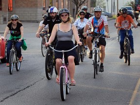 Veronica Samek, centre, riding her Flamingo pink coaster bike, travels with other members of Bike Friendly Windsor Essex on Devonshire Road.