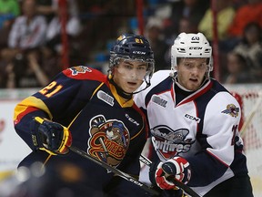 Erie Otters' Patrick Fellows and Windsor Spitfires' Andrew Burns fight for position during the Ontario Hockey League opening game against the Erie Otters at the WFCU Centre in Windsor, Ont. in this September 2015 file photo.