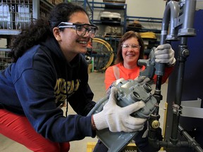 Daniela Espinosa-Perdomo, left, receives mentoring from gasfitter Melissa Fleming during a trades camp for young women at Union Gas on Rhodes Drive in Windsor on Tuesday, March 15,  2016.