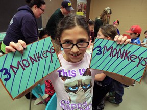 Madison Bacon, 12, proudly displays her bicycle license plates she created along with 22 other young students during March Break day camp at Optimist Community Centre March 16, 2016. Wednesday's theme was summer, so the children participated in summer activities in the gym and developed their artistic flare in the crafts room under the supervision of co-ordinator Taylor Tessier.