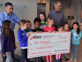 March Break Day Camp students are arranged by Joe Barile, left, general manager of Essex Powerlines, and LaSalle Mayor Ken Antaya, right, following a $10,000 donation by Essex Power Corporation to LaSalle's Youth in Community Fund at Vollmer Complex Friday March 18, 2016.
