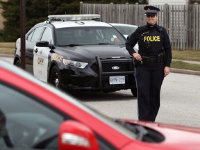 OPP Constable Karen Sinnaeve watching for distracted drivers at a four-way stop on McNorton Street near Tecumseh Arena Monday March 14, 2016. (NICK BRANCACCIO/Windsor Star)