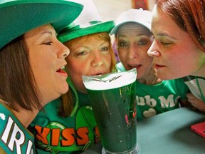 Lori Cunningham, left, Robin Larocque, Rebecca Crumb and Stephanie Drouillard share a jug of green beer and celebrate St. Patrick's Day at the Scottish Club of Windsor on Saturday, March 16, 2013. (REBECCA WRIGHT/ The Windsor Star)