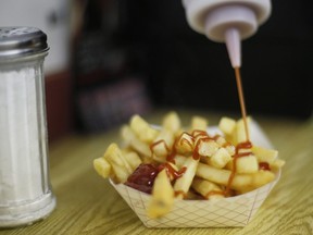 In this file photo, a customer douses her french fries with ketchup at the Saco Drive-In in Saco, Maine, June 26, 2014.