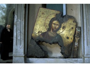 A half-burned image of Christ is seen at a Greek Orthodox church in Maaloula, Syria, an ancient Christian town northeast of Damascus. The U.S. on Thursday, March 17, joined the EU in declaring that ISIL is committing genocide against Christians and other minorities in Iraq and Syria.