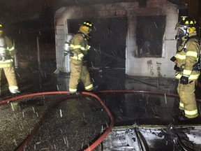 Amherstburg firefighters extinguish a garage fire on Balaclava Street in Amherstburg on Thursday, March 3, 2016.