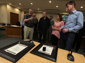 Mayor Tom Bain presents James Taylor, Stacey Lanoue and Chris Lanoue (left to right) with a Council recognition of Lakeshore residents for Lifesaving during a council meeting in Lakeshore on Tuesday, March 22, 2016. A three participated in saving the life of a man who fell in Belle River.