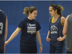 Lancers basketball player, Orian Amsalem, talks with head coach, Chantal Vallee, left,  during practice at the St. Denis Centre, Wednesday, Feb. 24, 2016.