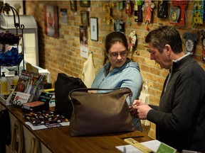 Blimeys British Store & Gift Shop owner Carl Hulme, right, and Tori Forsey, left, look over a recent delivery of new stock in Harrow, Ont., on March 24, 2016.