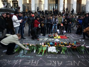 People leave tributes at the Place de la Bourse following today's attacks on March 22, 2016 in Brussels, Belgium. At least 30 people are thought to have been killed after Brussels airport and a Metro station were targeted by explosions. The attacks come just days after a key suspect in the Paris attacks, Salah Abdeslam, was captured in Brussels.