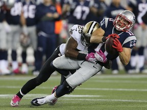 Defensive back Rafael Bush tackles New England receiver Julian Edelman during NFL action at Gillette Stadium on October 13, 2013 in Foxboro, Massachusetts. The Detroit Lions recently signed Bush.