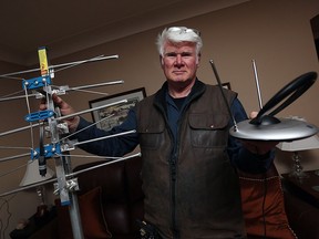 Russell Gray holds up examples of antennas at his Windsor home on Tuesday, March 1, 2016. The new skinny cable plans are available for $25 but in this area an antenna may allow you to get more channels.