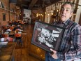Mark Boscariol, landlord and former business owner of Chanoso's at 255 Ouellette Ave., shows a photo of the eatery's original staff.