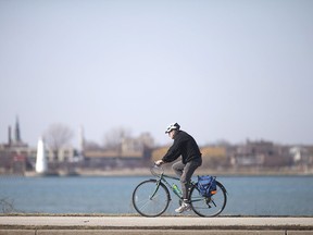 A cyclist cruises along Windsor's waterfront on a unseasonably warm day, Monday, March 7, 2016.
