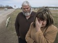 Carol-Ann Michaud, right, mother of Jean-Francois Michaud, and Dave Foulis, a close family friend, visit the site of her son's death on March 20, 2016 in the 200 block on Albuna Townline in Leamington.