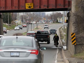 A cyclist braves the underpass on Dougall Avenue in Windsor on Monday, March 28, 2016. Cyclists are hoping the city will add some measures to make the area safer for cyclists.