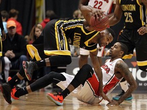 The Windsor Express' Brandon Robinson is knocked over by the London Lightning's Nick Okorie at the WFCU Centre in Windsor on Thursday, March 3, 2016.