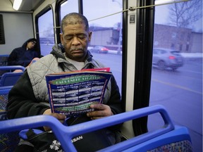 File- This Jan. 29, 2015, file photo shows James Robertson 56, of Detroit looking over ads for used cars while riding the SMART bus as a part of his commute to work. A Brookings Institution report out Tuesday, March 24, 2015, finds the number of jobs within typical commuting range dropped 7 percent between 2000 and 2012 in major U.S. metropolitan areas.