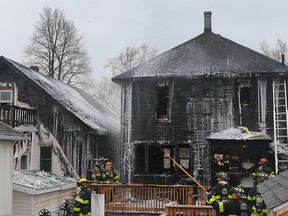 Windsor firefighters are shown at the scene of a fire on Wednesday, March 23, 2016, in the 1100 block of Hickory Rd. in Windsor, ON. The fire broke out shortly after 2:00 p.m. and caused extensive damage to two homes. (DAN JANISSE / Windsor Star)