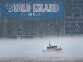 A U.S. Coast Guard boat navigates a foggy Detroit river on Monday, March 14, 2016.