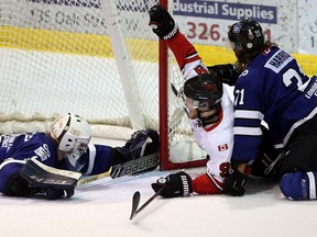 Leamington Flyers Mark Manchurek celebrates after scoring on London Nationals goaltender Connor Hughes during first period Greater Ontario Junior Hockey League playoff action in Leamington, Ontario on March 31, 2016.