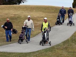 Rob Smith (left), Bob Tracey, Mike Palenchar, Chris Brennan, and Tom Steinke (right) leave the first tee at Orchard View Golf Club on March 9, 2016.