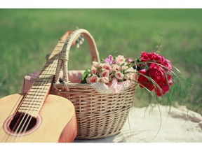 Guitar, basket and bouquet of flowers. Photo by fotolia.com.